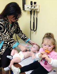 Pediatric Care North staff with child